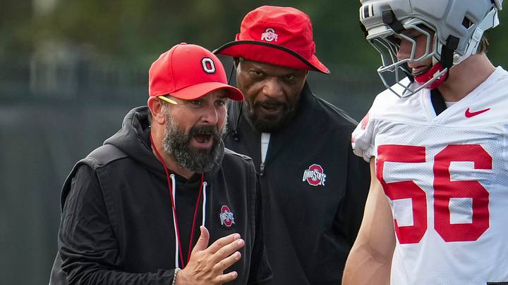 Ohio State Buckeyes defensive coordinator Matt Patricia and defensive line coach Larry Johnson talk to defensive end Nate Riegle (56) during the first practice of training camp at the Woody Hayes Athletic Center in Columbus on Aug. 6, 2026.
