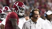 Sep 2, 2023; Tuscaloosa, Alabama, USA;  Alabama Crimson Tide quarterback Jalen Milroe (4) shakes hands with head coach Nick Saban after throwing a touchdown pass against the Middle Tennessee Blue Raiders during the second half at Bryant-Denny Stadium. Alabama won 56-7. Mandatory Credit: Gary Cosby Jr.-Imagn Images