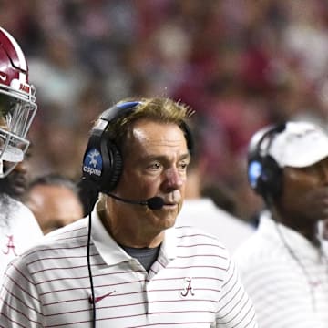 Sep 2, 2023; Tuscaloosa, Alabama, USA;  Alabama Crimson Tide quarterback Jalen Milroe (4) shakes hands with head coach Nick Saban after throwing a touchdown pass against the Middle Tennessee Blue Raiders during the second half at Bryant-Denny Stadium. Alabama won 56-7. Mandatory Credit: Gary Cosby Jr.-Imagn Images