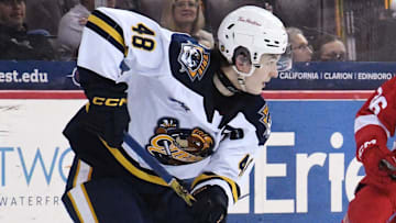 Erie Otters defenseman Matthew Schaeffer, left, works near Sault Ste. Marie Greyhounds forward Marco Mignosa at Erie Insurance Arena in Erie on Nov. 22, 2024.