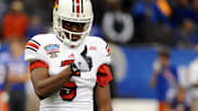 Jan 2, 2013; New Orleans, LA, USA; Louisville Cardinals quarterback Teddy Bridgewater (5) signals to the bench late in the second half of the Sugar Bowl against the Florida Gators at the Mercedes-Benz Superdome. Mandatory Credit: Chuck Cook-Imagn Images
