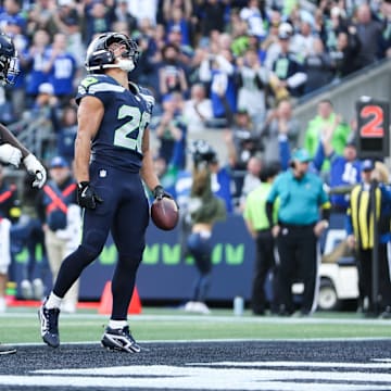 Nov 9, 2025; Seattle, Washington, USA; Seattle Seahawks running back Zach Charbonnet (26) celebrates after scoring a touchdown during the second quarter against the Arizona Cardinals at Lumen Field. 