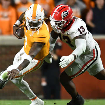 Tennessee quarterback Joe Milton III (7) is defended by Georgia defensive lineman Mykel Williams (13) during a football game between Tennessee and Georgia at Neyland Stadium in Knoxville, Tenn., on Saturday, Nov. 18, 2023.