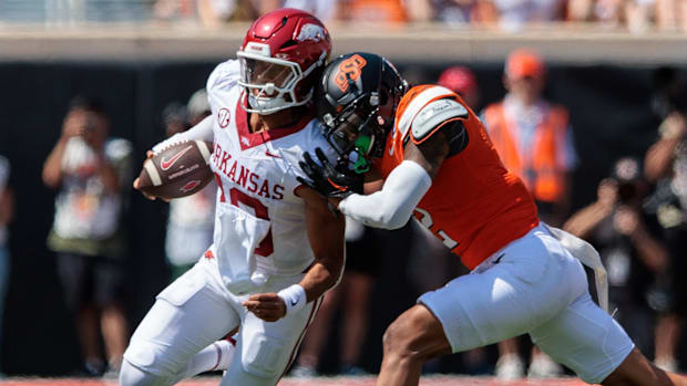 Arkansas quarterback Taylen Green is hit by Oklahoma State linebacker Jeff Roberson.