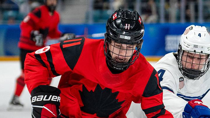 Jan 30, 2024; Gangwon-do, KOR; Tynan Lawrence (CAN) skates with the puck while under pressure from AJ Francisco (USA) in the Ice Hockey Men s 6-on-6 Tournament Semifinals between Canada and (USA) at the Gangneung Hockey Centre. The Winter Youth Olympic Games, Gangwon, South Korea, Tuesday 30 January 2024. Mandatory Credit: OIS/Thomas Lovelock-Imagn Images