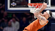 Texas guard Chendall Weaver (2) hangs on the rim after basket by a teammate against Vanderbilt during a NCAA college basketball first round game at the men’s Southeastern Conference Tournament Wednesday, March 12, 2025, in Nashville, Tenn.