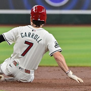 Apr 17, 2024; Phoenix, Arizona, USA;  Arizona Diamondbacks outfielder Corbin Carroll (7) steals second base in the first inning against the Chicago Cubs at Chase Field. Mandatory Credit: Matt Kartozian-Imagn Images