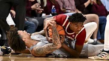 Feb 15, 2025; College Station, Texas, USA; Texas A&M Aggies forward Andersson Garcia (11) and Arkansas Razorbacks forward Karter Knox (11) battle for a loose ball during the second half at Reed Arena. Mandatory Credit: Maria Lysaker-Imagn Images 