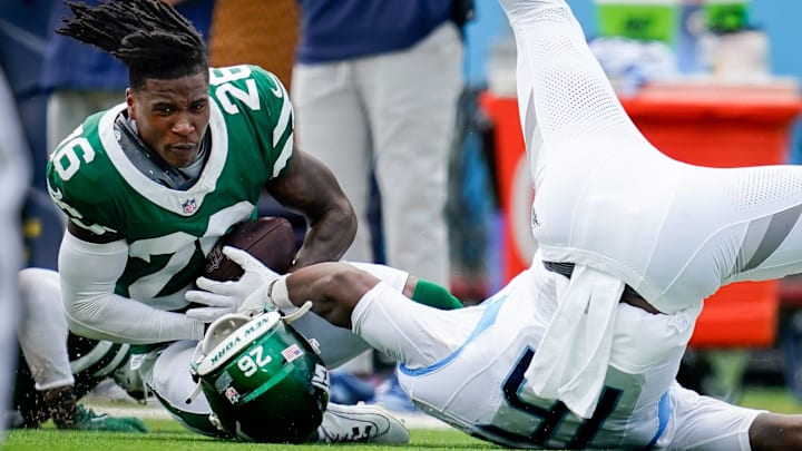 New York Jets cornerback Brandin Echols (26) intercepts a ball intended for Tennessee Titans wide receiver Treylon Burks (16) during the second quarter at Nissan Stadium in Nashville, Tenn., Sunday, Sept. 15, 2024.