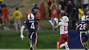 Sep 20, 2025; Charlottesville, Virginia, USA; Stanford Cardinal wide receiver Bryce Farrell (11) catches a touchdown pass as Virginia Cavaliers defensive back Christian Charles (4) and Cavaliers defensive back Donavon Platt (28) chase during the third quarter at Scott Stadium. Mandatory Credit: Geoff Burke-Imagn Images