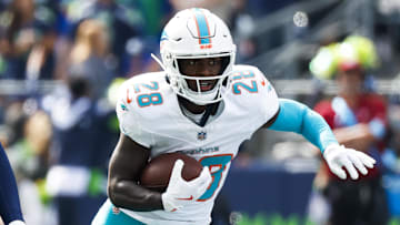 Sep 22, 2024; Seattle, Washington, USA; Miami Dolphins running back DeVon Achane (28) rushes against the Seattle Seahawks during the first quarter at Lumen Field. Mandatory Credit: Joe Nicholson-Imagn Images