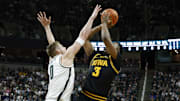Michigan State Spartans forward Jaxon Kohler (0) contests a shot from Iowa Hawkeyes forward Cam Manyawu (3) at the Breslin Center on Tuesday, Dec. 2, 2025.