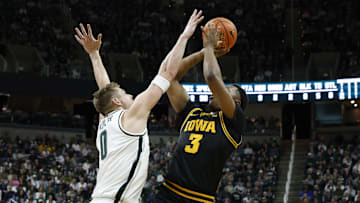Michigan State Spartans forward Jaxon Kohler (0) contests a shot from Iowa Hawkeyes forward Cam Manyawu (3) at the Breslin Center on Tuesday, Dec. 2, 2025.