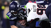 Houston Texans defensive end Denico Autry (96) tackles Seattle Seahawks quarterback Sam Darnold (14) during the fourth quarter at Lumen Field.