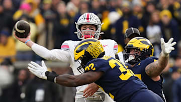 Nov 25, 2023; Ann Arbor, Michigan, USA; Ohio State Buckeyes quarterback Kyle McCord (6) is hit by