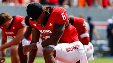 Sep 6, 2025; Raleigh, North Carolina, USA; North Carolina State Wolfpack wide receiver Wesley Grimes (6) prays prior to the first half of the game against Virginia Cavaliers at Carter-Finley Stadium. Mandatory Credit: Jaylynn Nash-Imagn Images