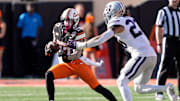 Kansas State linebacker Asa Newsom chases down Oklahoma State's Gavin Freeman in second half on Saturday. K-State won, 14-6.