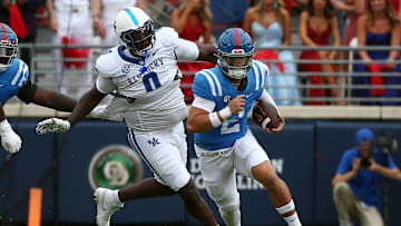 Sep 28, 2024; Oxford, Mississippi, USA; Mississippi Rebels quarterback Jaxson Dart (2) runs the ball as Kentucky Wildcats defensive linemen Deone Walker (0) pursues during the first half