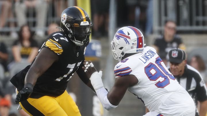 Aug 19, 2023; Pittsburgh, Pennsylvania, USA;  Pittsburgh Steelers offensive tackle Broderick Jones (77) run blocks at the line of scrimmage against Buffalo Bills defensive end Shaq Lawson (90) during the second quarter at Acrisure Stadium. Mandatory Credit: Charles LeClaire-Imagn Images