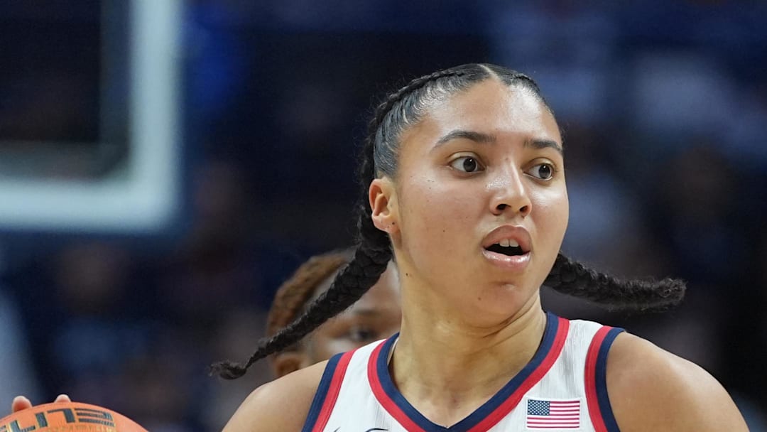 UConn Huskies guard Azzi Fudd returns the ball against the Providence Friars.