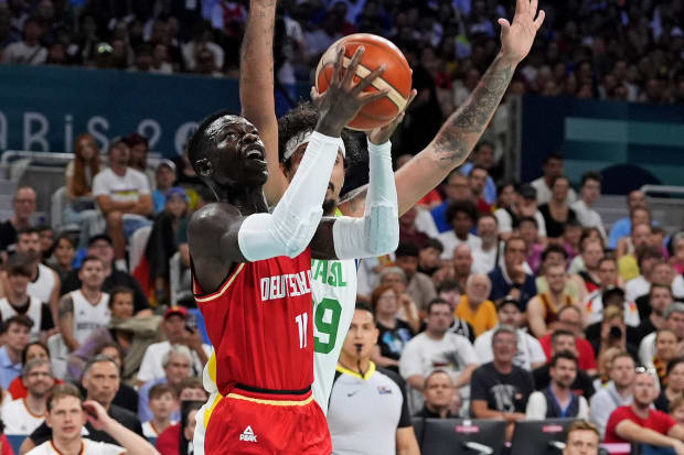 Germany point guard Dennis Schroder drives to the basket against Brazil power forward Lucas Dias.