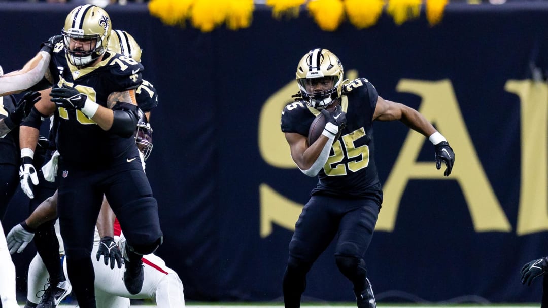 Jan 7, 2024; New Orleans, Louisiana, USA;  New Orleans Saints running back Kendre Miller (25) runs against the Atlanta Falcons during the first half at Caesars Superdome. Mandatory Credit: Stephen Lew-USA TODAY Sports