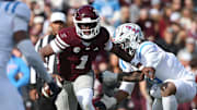 Mississippi State Bulldogs quarterback Kamario Taylor (1) runs against Mississippi Rebels linebacker TJ Dottery (6) in the second half at Davis Wade Stadium at Scott Field.