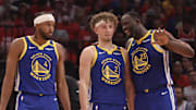 Apr 30, 2025; Houston, Texas, USA; Golden State Warriors forward Draymond Green (23) talks to guard Brandin Podziemski (2) and guard Moses Moody (4) before playing against the Houston Rockets in the second quarter during game five of first round for the 2025 NBA Playoffs at Toyota Center. Mandatory Credit: Thomas Shea-Imagn Images