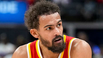 Trae Young #11 of the Atlanta Hawks rests between possessions against the Detroit Pistons.