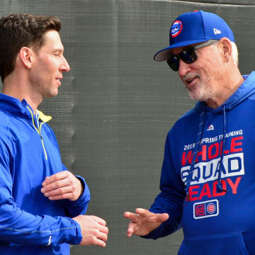 Feb 13, 2019; Mesa, AZ, USA; Chicago Cubs manager Joe Maddon (right) talks with director of strategic initiatives Craig Breslow during a spring training workout at Sloan Park. Mandatory Credit: Matt Kartozian-USA TODAY Sports