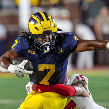 Michigan running back Donovan Edwards (7) is tackled by Fresno State defensive back Julian Neal (15) during the 1st half against Fresno State at Michigan Stadium at Michigan Stadium in Ann Arbor on Saturday, Aug. 31, 2024.