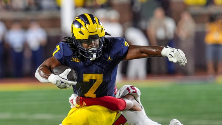 Michigan running back Donovan Edwards (7) is tackled by Fresno State defensive back Julian Neal (15) during the 1st half against Fresno State at Michigan Stadium at Michigan Stadium in Ann Arbor on Saturday, Aug. 31, 2024.