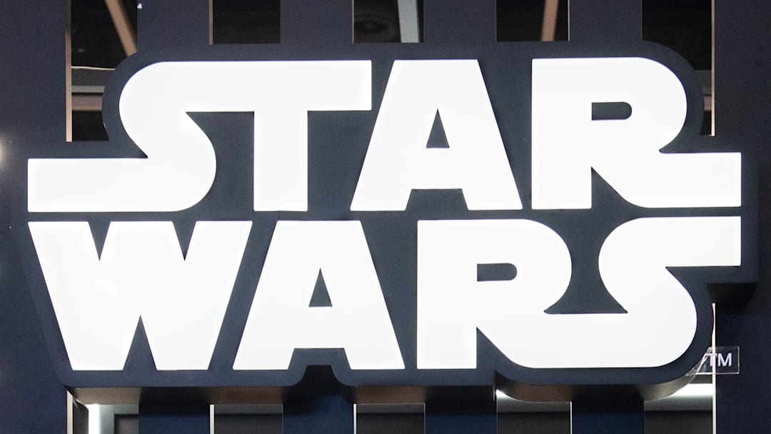 Visitors are seen at Disney's Star Wars booth.