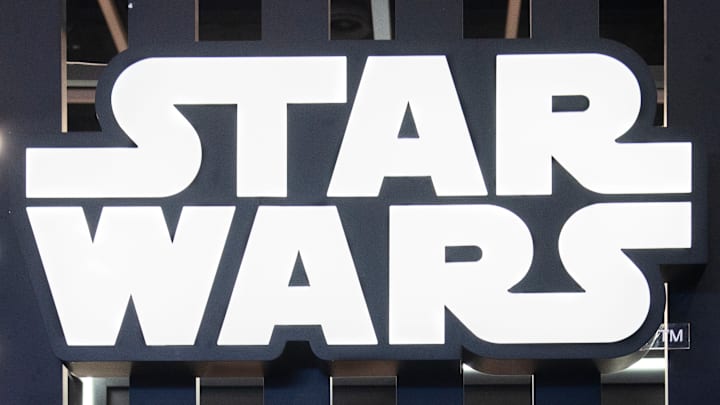 Visitors are seen at Disney's Star Wars booth.