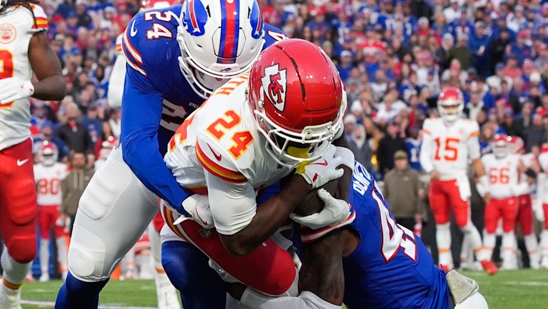 Nov 2, 2025; Orchard Park, New York, USA; Kansas City Chiefs running back Brashard Smith (24) is brought down by Buffalo Bills safety Cole Bishop (24) and cornerback Christian Benford (47) in the first quarter at Highmark Stadium. Mandatory Credit: Gregory Fisher-Imagn Images