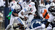 Dec 21, 2024; University Park, Pennsylvania, USA; Southern Methodist Mustangs quarterback Kevin Jennings (7) is sacked by Penn State Nittany Lions defensive end Abdul Carter (11) during the third quarter in the first round of the College Football Playoff at Beaver Stadium.  