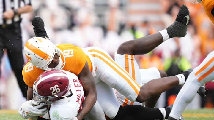 Tennessee defensive lineman Joshua Josephs (19) tackles Alabama running back Jam Miller (26) during a game between Tennessee and Alabama at Neyland Stadium in Knoxville, Tenn., Saturday, Oct. 19, 2024.