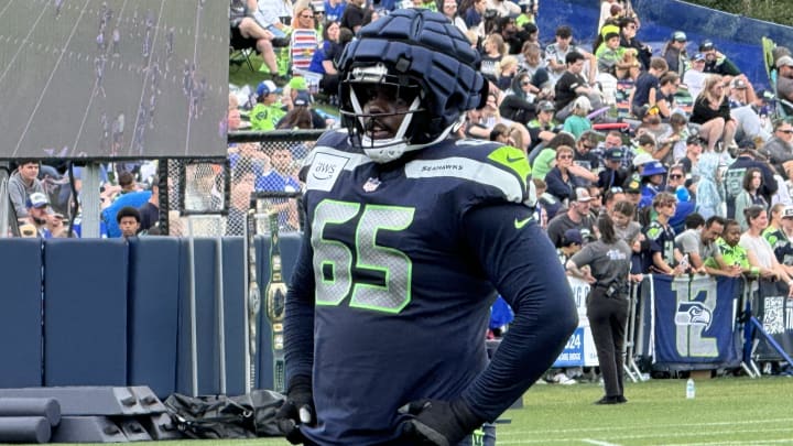 Seattle Seahawks tackle Mike Jerrell listens to instruction from coach Scott Huff during training camp.