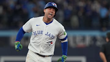 Oct 20, 2025; Toronto, Ontario, CAN; Toronto Blue Jays designated hitter George Springer (4) celebrates after hitting a three-run home run in the seventh inning against the Seattle Mariners during game seven of the ALCS round for the 2025 MLB playoffs at Rogers Centre.