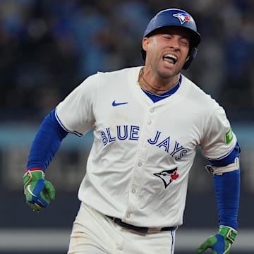 Oct 20, 2025; Toronto, Ontario, CAN; Toronto Blue Jays designated hitter George Springer (4) celebrates after hitting a three-run home run in the seventh inning against the Seattle Mariners during game seven of the ALCS round for the 2025 MLB playoffs at Rogers Centre.