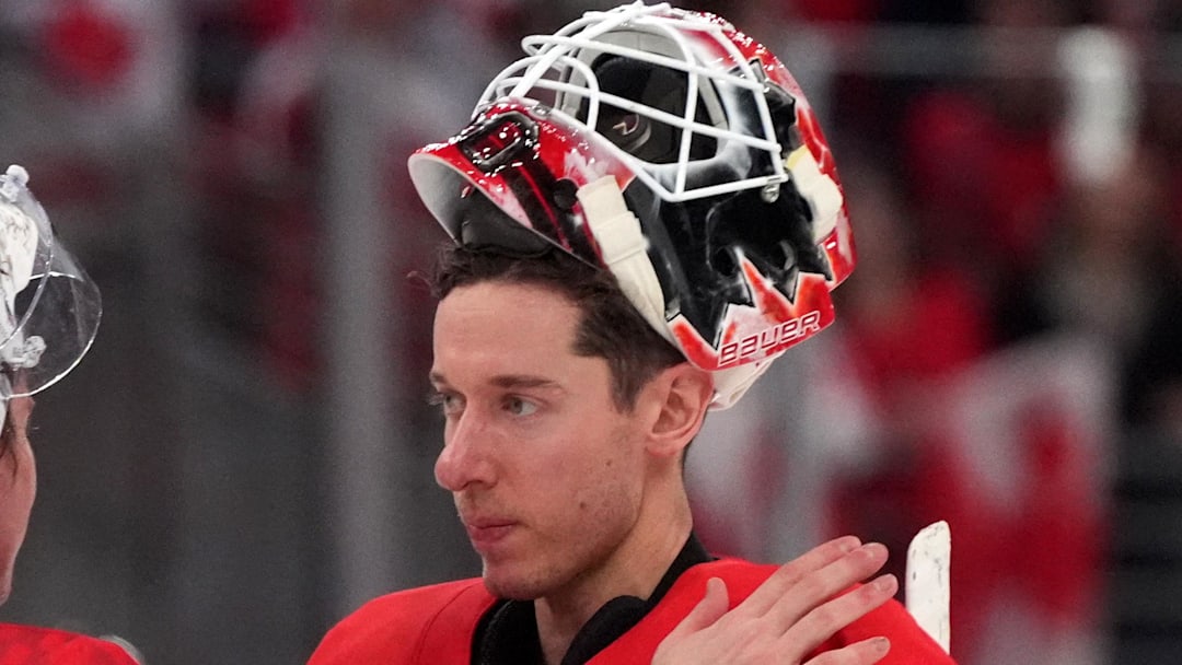 Feb 18, 2026; Milan, Italy; Lukas Dostal of Czech Republic and Jordan Binnington of Canada after the match  in a men's ice hockey quarterfinal during the Milano Cortina 2026 Olympic Winter Games at Milano Santagiulia Ice Hockey Arena. Mandatory Credit: Amber Searls-Imagn Images