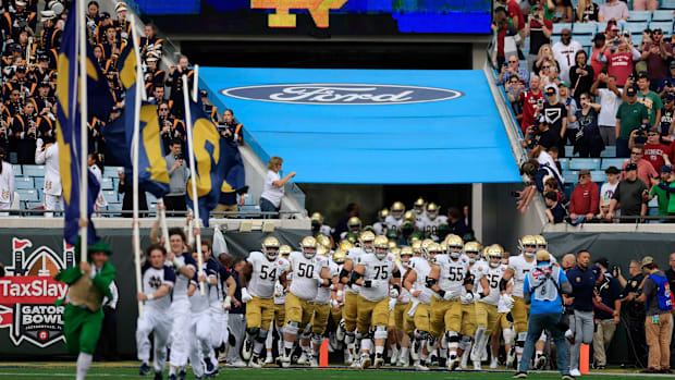 The Notre Dame football team takes the field at the 2022 Gator Bow