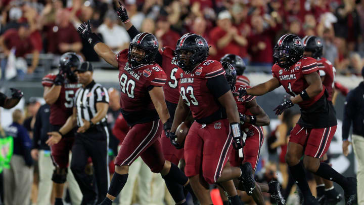 South Carolina football defensive tackles TJ Sanders (90) and Nick Barrett (93) and defensive back DQ Smith (1) celebrating during the 2022 Gator Bowl against the Notre Dame Fighting Irish