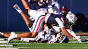 Nov 8, 2025; Tucson, Arizona, USA; Arizona Wildcats defensive lineman Dominic Lolesio (42) tackles Kansas Jayhawks wide receiver Bryson Canty (11) during the third quarter of the game at Arizona Stadium. Mandatory Credit: Aryanna Frank-Imagn Images