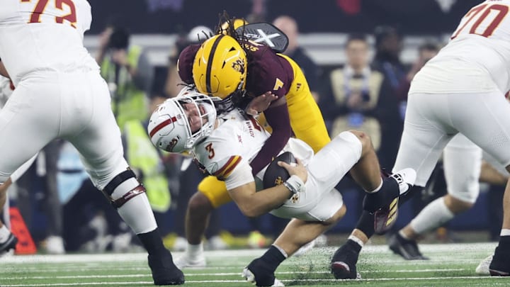 Arizona State defensive back Simmons tackles Iowa State quarterback Becht during the second half at AT&T Stadium. Arizona State defensive back Simmons tackles Iowa State quarterback Becht during the second half at AT&T Stadium.