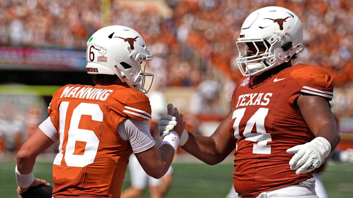 Sep 13, 2025; Austin, Texas, USA; Texas Longhorns quarterback Arch Manning (16) and offensive lineman Trevor Goosby (74) react after Manning ran for a touchdown during the first half against the Texas El Paso Miners at Darrell K Royal-Texas Memorial Stadium. Mandatory Credit: Scott Wachter-Imagn Images