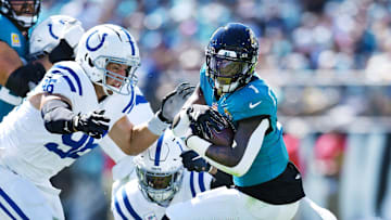 Indianapolis Colts defensive tackle Taven Bryan (96) and teammates try to stop Jacksonville Jaguars running back Travis Etienne Jr. (1) during first quarter action. The Jacksonville Jaguars hosted the Indianapolis Colts at EverBank Stadium in Jacksonville, FL Sunday, October 15, 2023. The Jaguars ended the first half with a 21 to 6 lead. [Bob Self/Florida Times-Union]