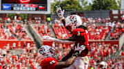 Sep 6, 2025; Raleigh, North Carolina, USA; North Carolina State Wolfpack running back Hollywood Smothers (3), and offensive lineman Jacarrius Peak (65) celebrate a touchdown during the second half of the game against Virginia Cavaliers at Carter-Finley Stadium. Mandatory Credit: Jaylynn Nash-Imagn Images