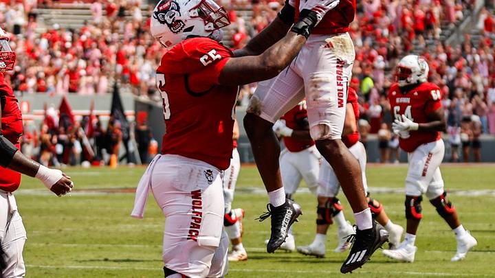 Sep 6, 2025; Raleigh, North Carolina, USA; North Carolina State Wolfpack running back Hollywood Smothers (3), and offensive lineman Matt McCabe (66) celebrate a touchdown during the second half of the game against Virginia Cavaliers at Carter-Finley Stadium. Mandatory Credit: Jaylynn Nash-Imagn Images