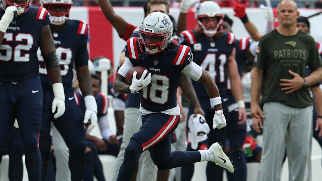 Nov 9, 2025; Tampa, Florida, USA; New England Patriots wide receiver Kyle Williams (18) runs for a touchdown during the second quarter against the Tampa Bay Buccaneers at Raymond James Stadium. Mandatory Credit: Nathan Ray Seebeck-Imagn Images